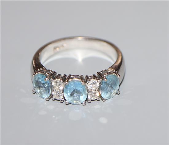 A modern 18ct white metal, aquamarine and diamond set seven stone half hoop ring, size O.